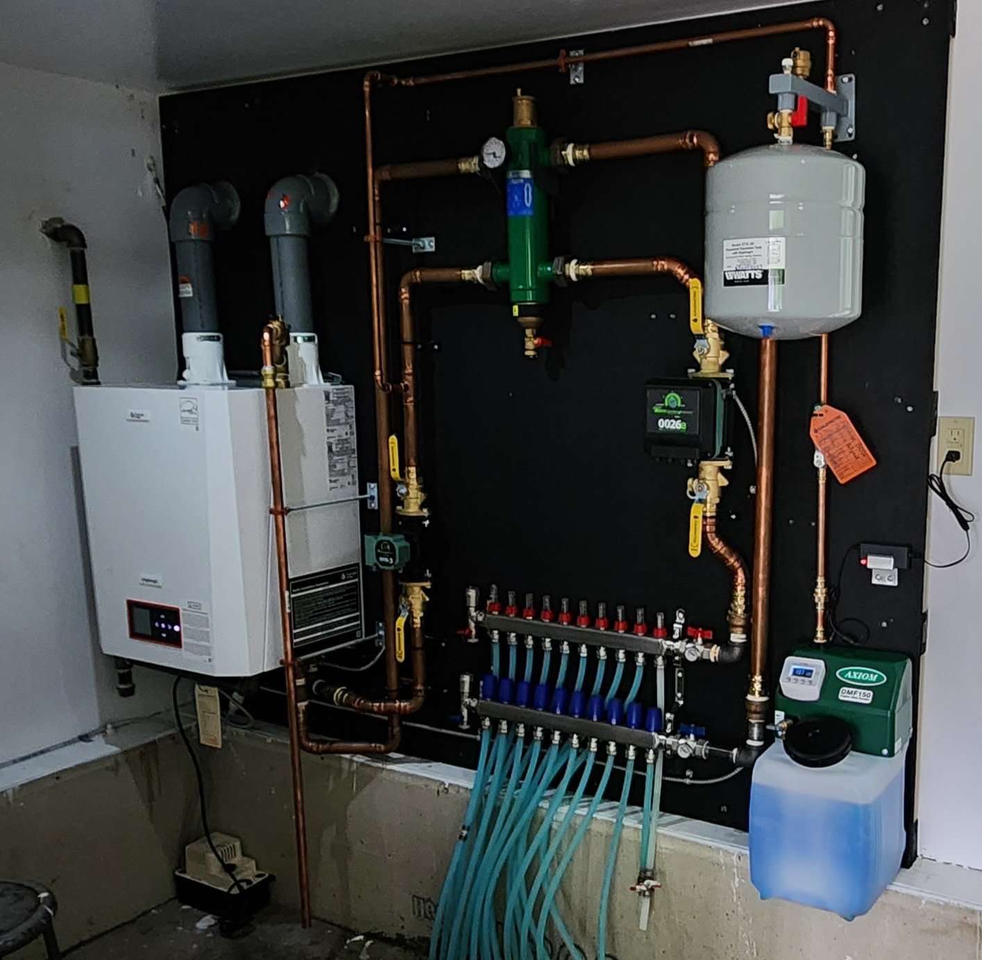 Hydronic boiler and radiant manifold in a custom home mechanical room