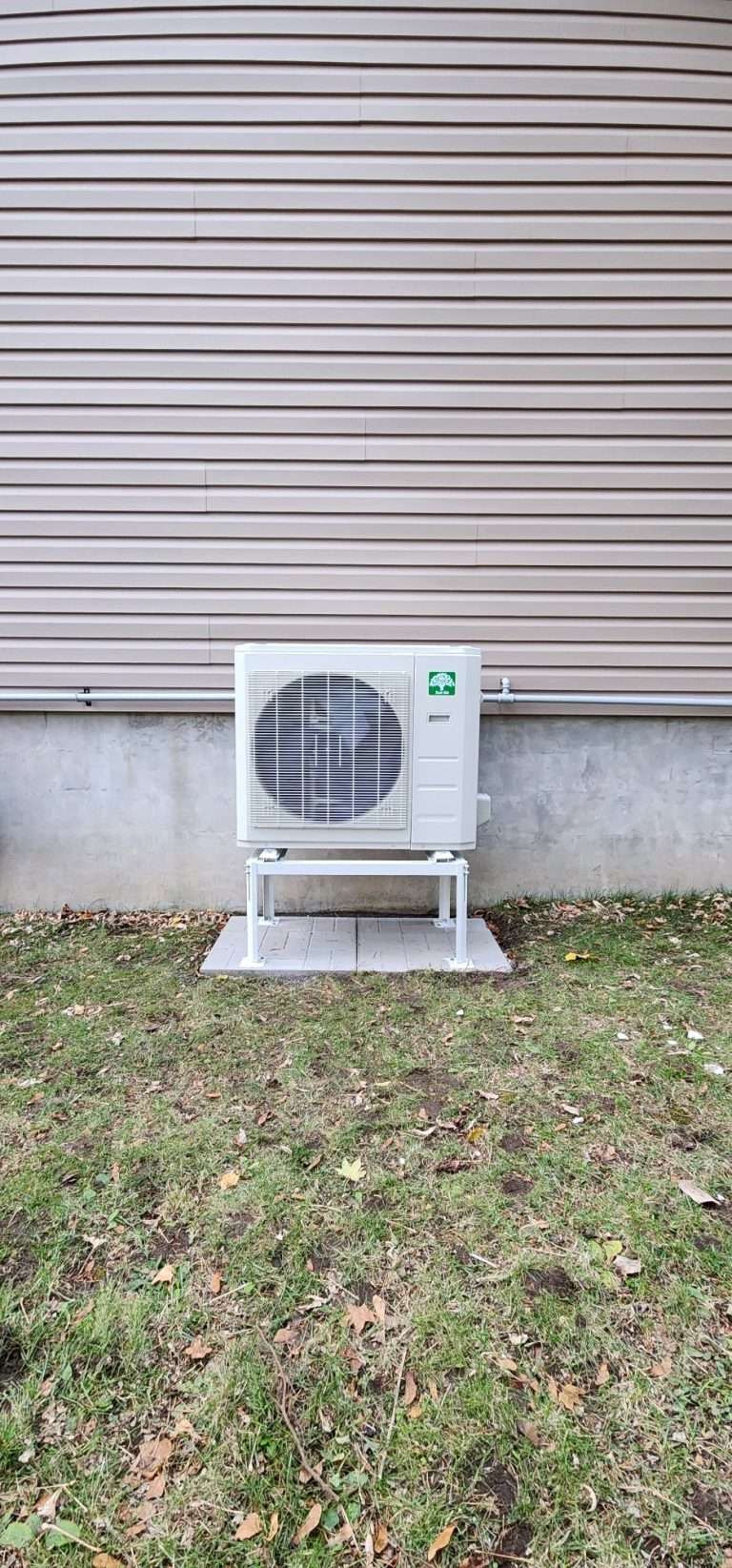 Ductless mini-split heat pump head mounted on a bedroom wall