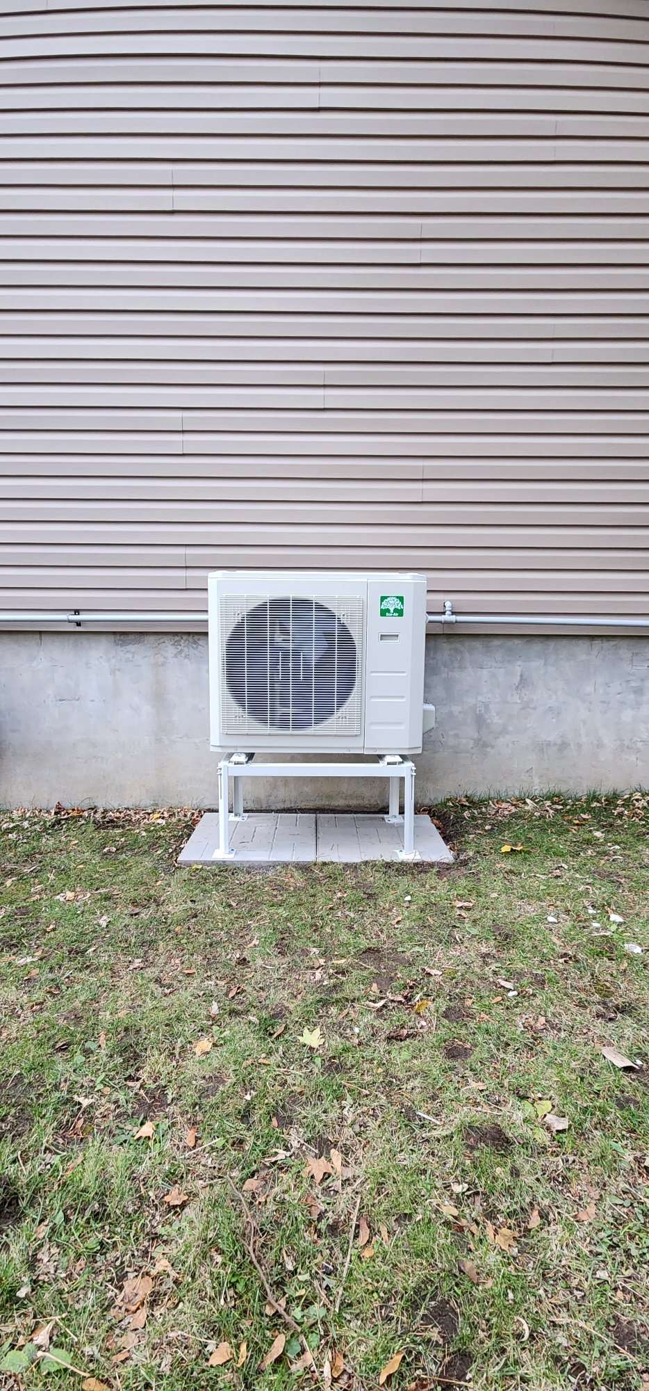 Ductless mini-split heat pump head mounted on a bedroom wall