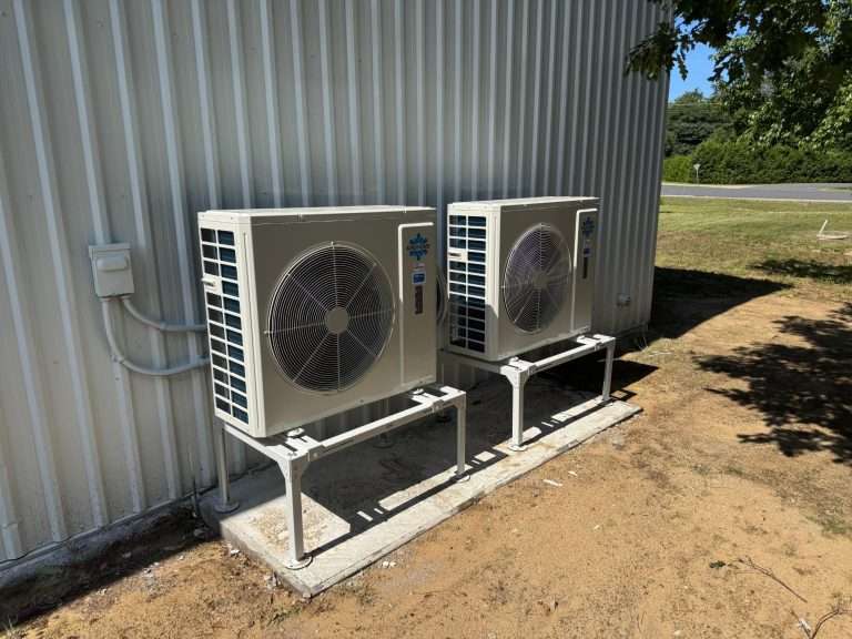 Two cold-climate heat pump outdoor units beside a Simcoe County home