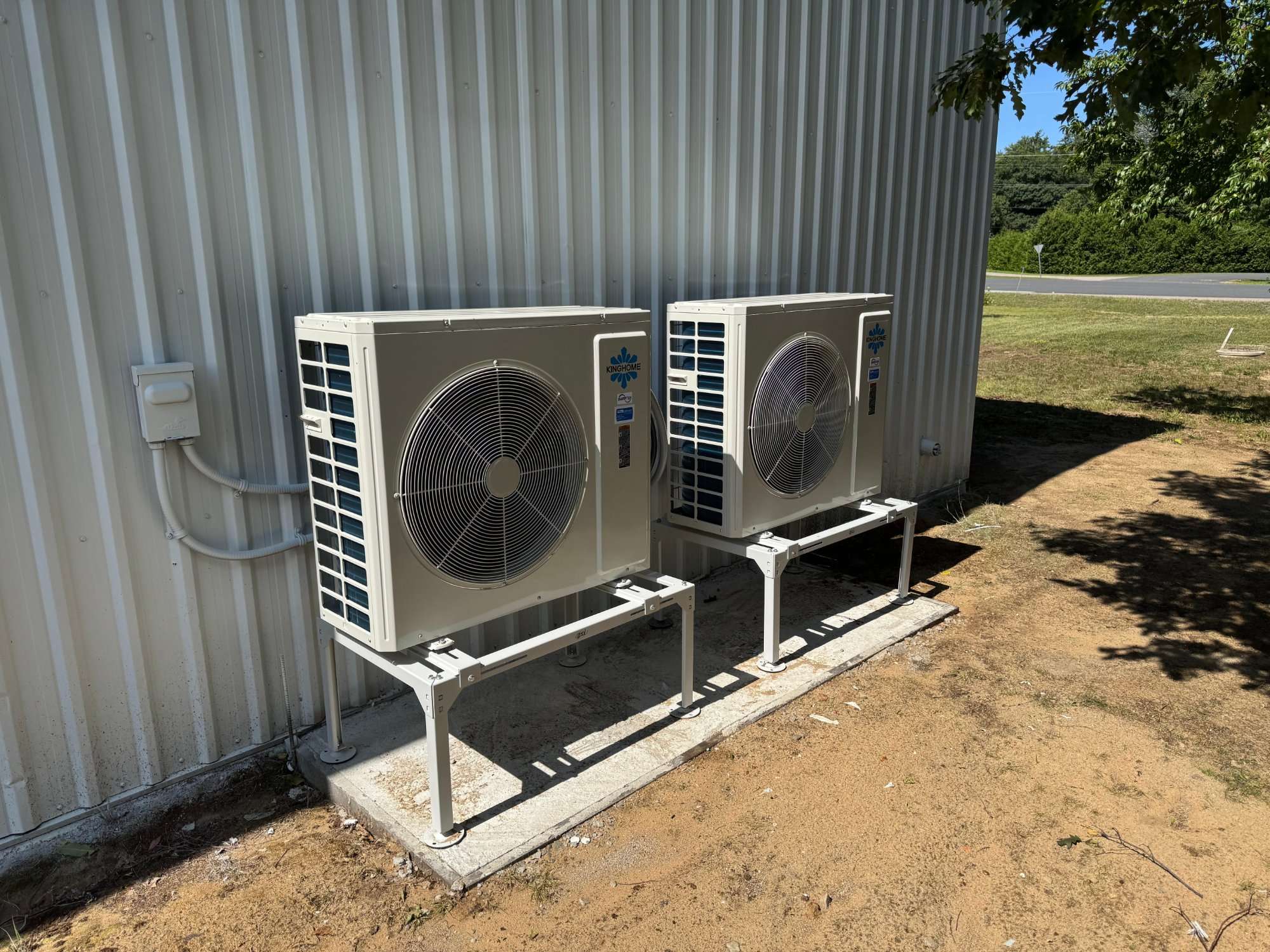 Two cold-climate heat pump outdoor units beside a Simcoe County home