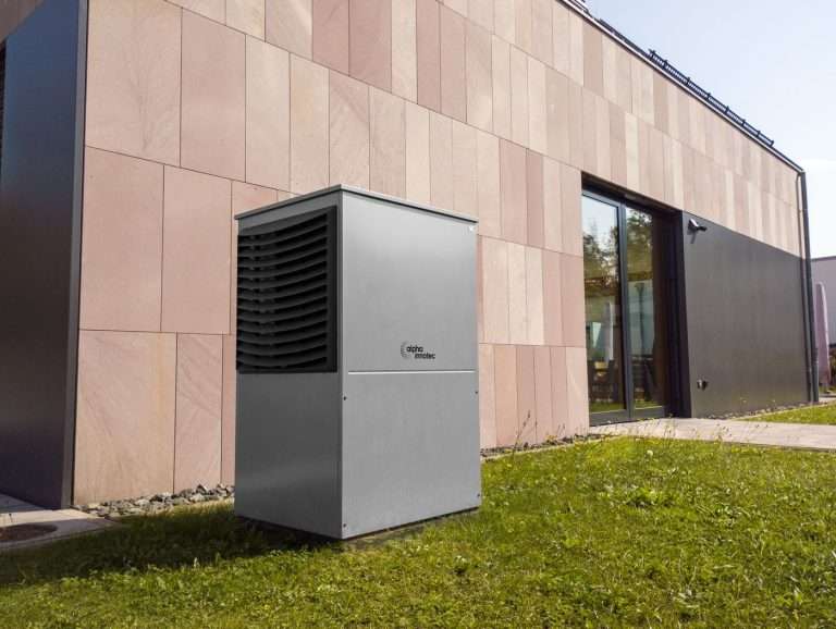 Air-source heat pump outdoor unit on a residential wall
