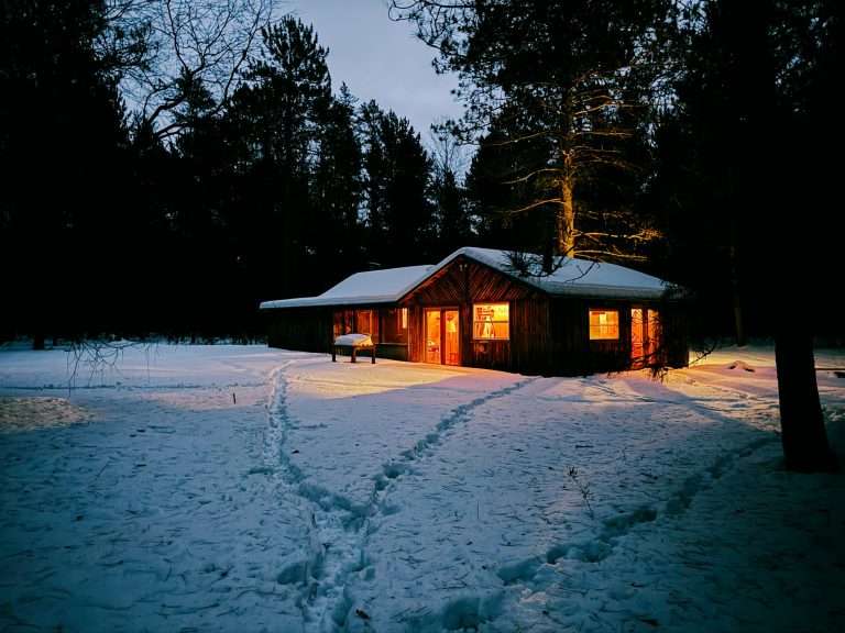 Snow-covered driveway and walkway at a winter cottage